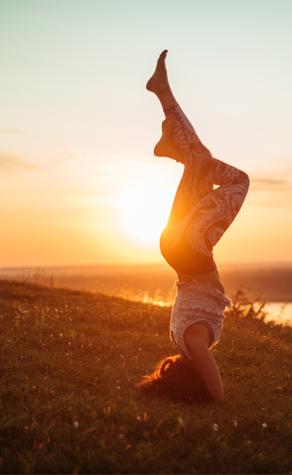 Outdoor yoga class facing the sea at sunrise at the hotel